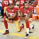 Colin Kaepernick, No. 7, and Eric Reid of the San Francisco 49ers kneel in protest during the national anthem before playing the Los Angeles Rams at Levi’s Stadium in Santa Clara, Calif., on Sept. 12, 2016. (Thearon W. Henderson/Getty Images)
